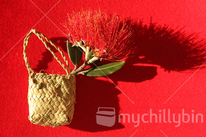 Flax bag with a Pohutukawa blossom 