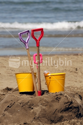 Bucket and spade at Long Bay beach, North Shore

