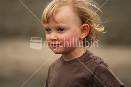 Child enjoying the breeze at the beach