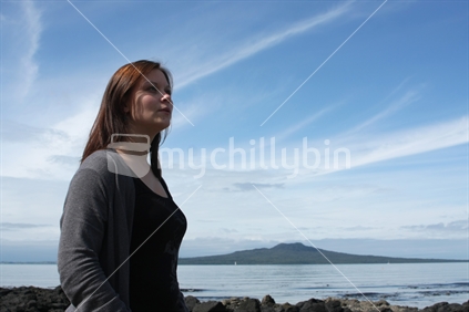 Woman with Rangitoto Island in the background, Takapuna, North Shore