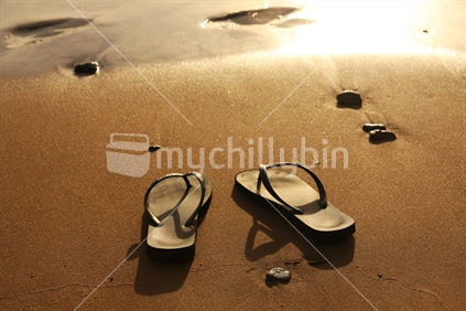 Thongs on the New Zeland beach at sunset; barefoot now!
