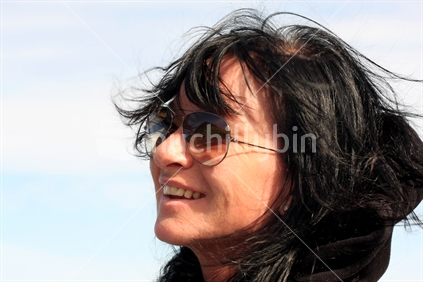 Woman smiling in the New Zealand wind.