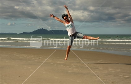 Jumping at a New Zealand beach.