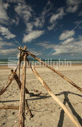 Driftwood structure, at Waipu Cove beach, New Zealand
