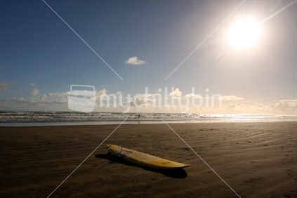 Surfboard lying on the beach, Muriwai, Waitakere, West Coast, Auckland, New Zealand
