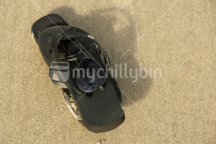 Jandals and sunglasses on the beach. No. 1.