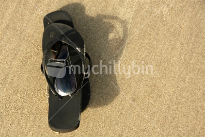 Jandals and sunglasses on the beach. No. 2.
