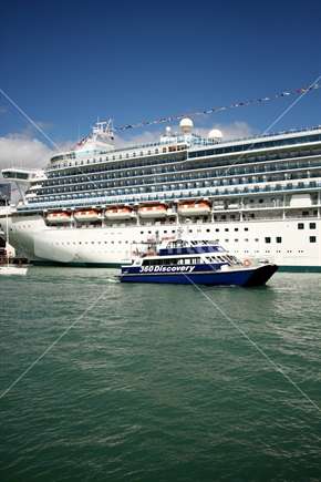 Cruise ship in Auckland, with local 360 Discover cruise boat in front.