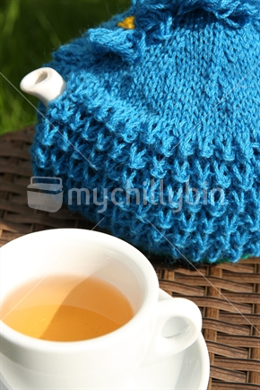 Teapot with a knitted tea cosy

