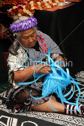 Woman from Kiribati weaving, Pasifika 2012, Auckland
