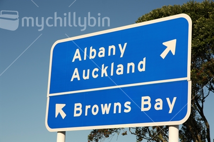 Road sign indicating Albany, Auckland and Browns Bay