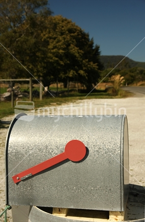 Rural letter box with a red flag