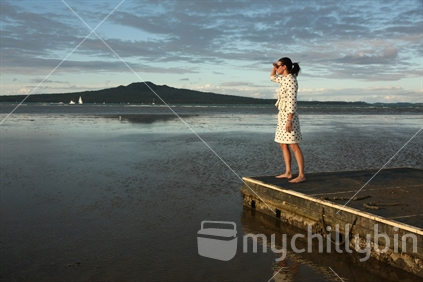 Business woman standing on a raft, Cheltenham Beach, Devonport, Auckland