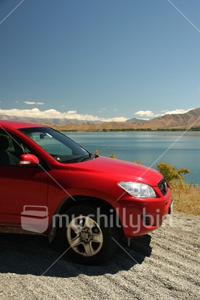 4WD car parked in front of Lake Benmore, Canterbury, Souh Island