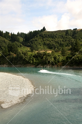 Rakaia River with a distant jetboat, Canterbury, South Island