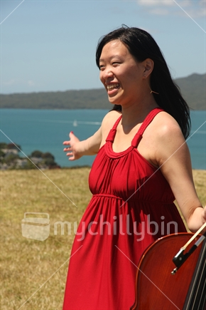 Woman with a cello on top of Mount Victoria, Devonport, Auckland