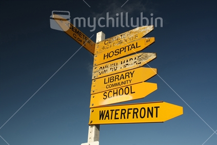 Well worn signs in Akaroa, Canterbury, South Island