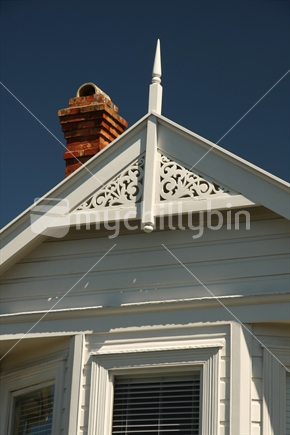 Weatherboard, fretwork, finial and chimney