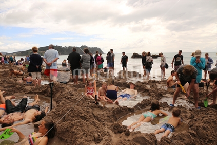 crowded Hot Water Beach on a cloudy day, Hahei, Coromandel