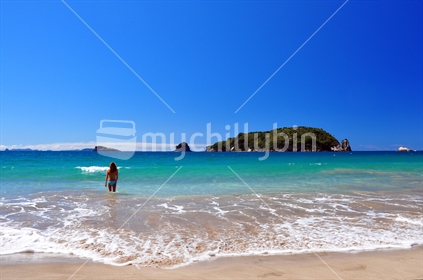 Young woman in Bikini in clear blue New Zealand coastal water.