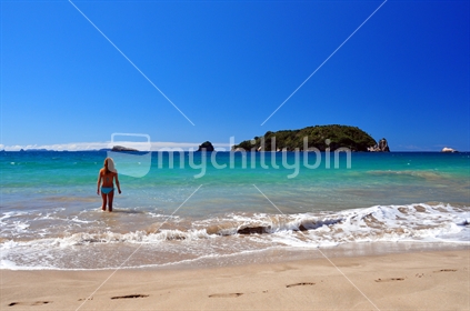 Young woman in Bikini, in clear blue coastal New Zealand water.