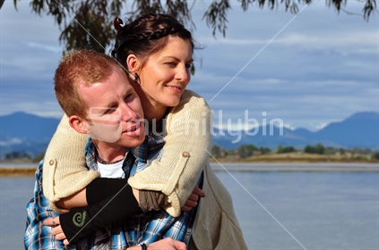 Couple on estuary edge, Mapua, New Zealand.