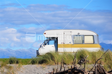 Camper van parked at a West Coast New Zealand beach.