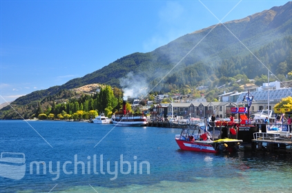 Waterfront scene in Queenstown, with smoke from the historic Earnslaw drifting across. 