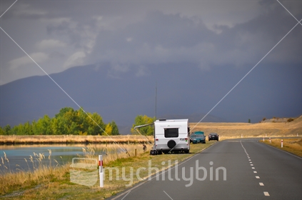 Fishing beside a caravan parked beside the hydro canal at Twizel in the Mackenzie Basin.