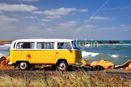 Yellow Volkswagon camper parked at the beach in southland