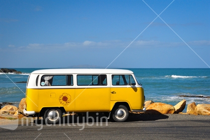 Yellow Volkswagon camper parked at the beach in southland