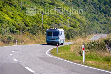 old bus travelling along coastal westcoast road