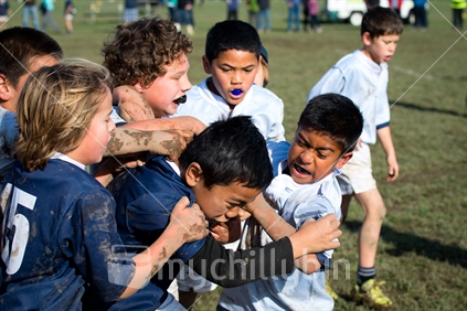 Young ethnically diverse kids playing rugby