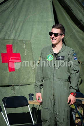 Young RNZAF pilot sanding by first aid tent at Airforce training Camp in Nelson