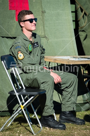 Young RNZAF pilot by first aid tent at Airforce training Camp in Nelson