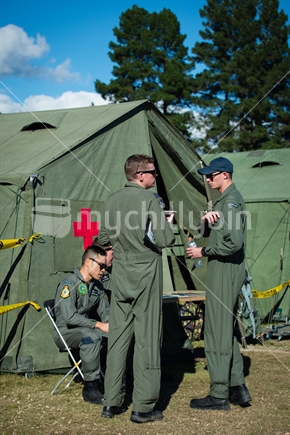 RNZAF men sitting outside airforce medical first aid tent at training camp in Nelson