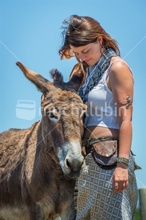 Young woman interacting with Donkey at Farm Park in Tasman district