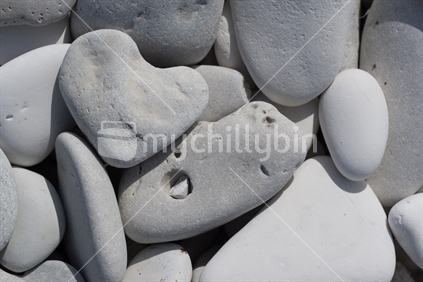 Heart pebble alongside other shaped rocks on Kaikoura Beach