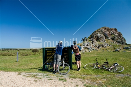 Bikers having a rest stop at Kaituna Quarry on the Little River Rail trail, New Zealand