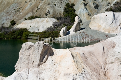 The lake and scenery at St Bathans, an old mining area, showing the white clay and rock formations, New Zealand