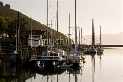 marina, early morning, sun just up over hills and catching the moored yachts