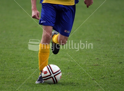Soccer player dribbling ball