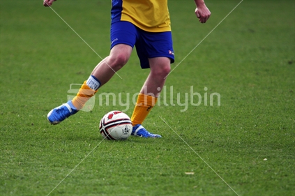 Soccer player dribbling ball