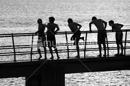 Summer fun, group of boys on bridge preparing to jump