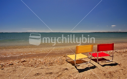 two sun chairs on beach
