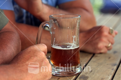 Beer glass held by hand