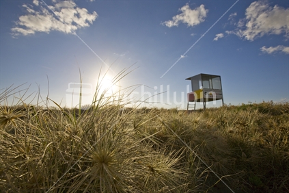 Lonely surf life guard tower at Piha beach