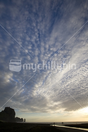 Beautiful cloud formations at dusk over Piha beach