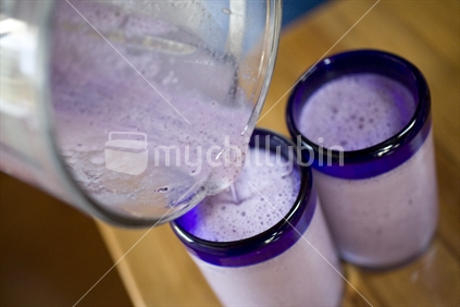 Pouring berry smoothies