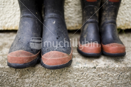 Adult and child's gumboots on a doorstep